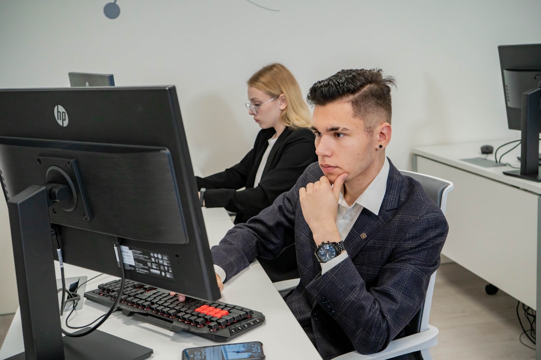 a man sitting at a desk in front of a computer