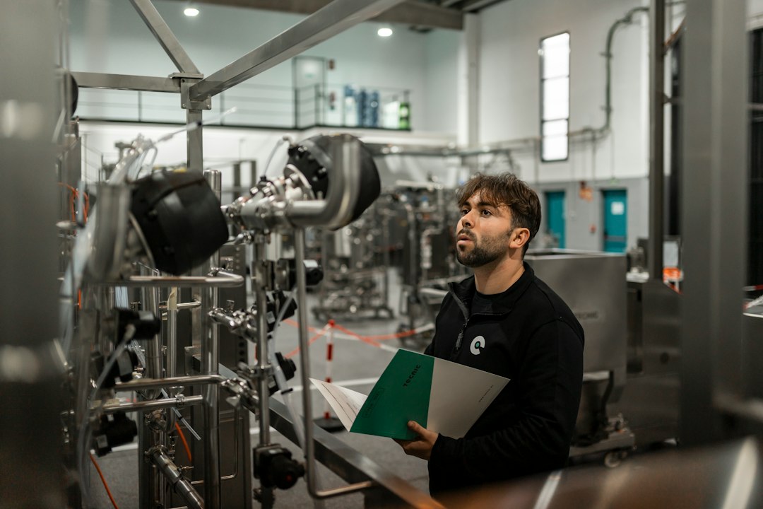 A man inspects machinery in a factory