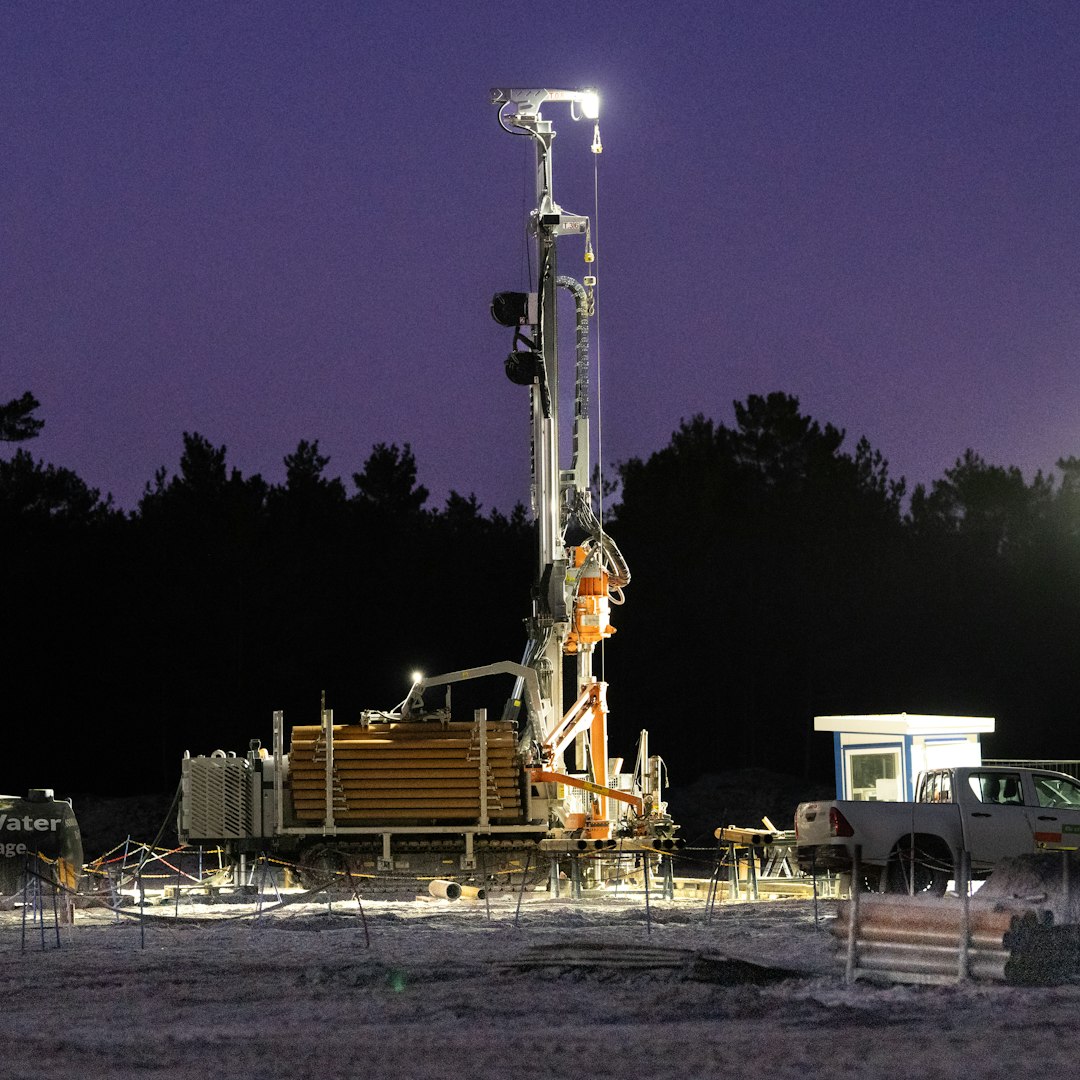 Drilling rig operating at night with lights on